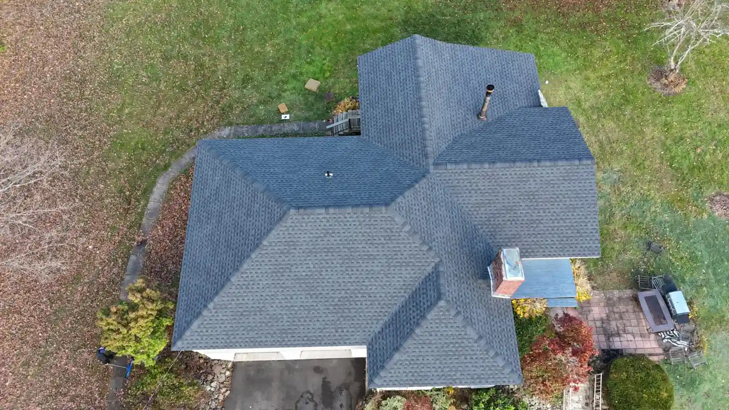 Aerial view of a house with a new grey shingle roof
